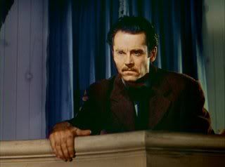 A grim Frank James (Henry Fonda) watches Bob Ford re-enact the murder of his brother.