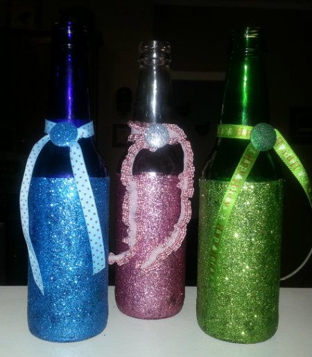 Beer and Soda Bottles Covered in Glitter reused as a a vase with embellisments