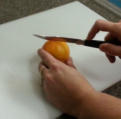 Cutting the clementine around the middle