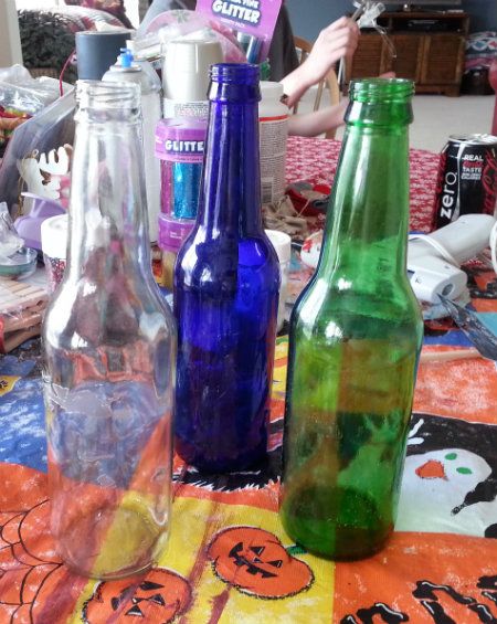 Empty Soda and Beer Bottles getting ready to be hit with some glitter and repurposed as vases