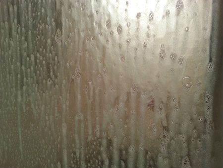 White Vinegar and Blue Dawn mixture on shower door getting rid of soap scum
