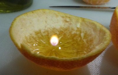 a lit clementine candle