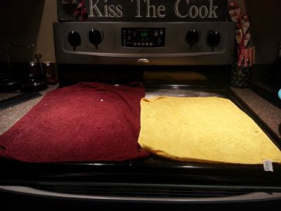 damp towels laying on top of baking soda cleaning a glass stove top