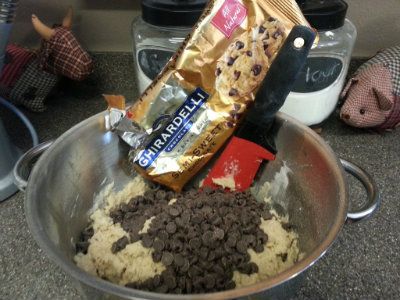 Chocolate Chips being added to the cookies