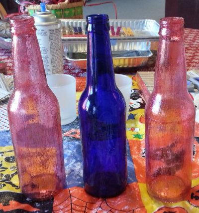 Red tinted bottles done with modge podge